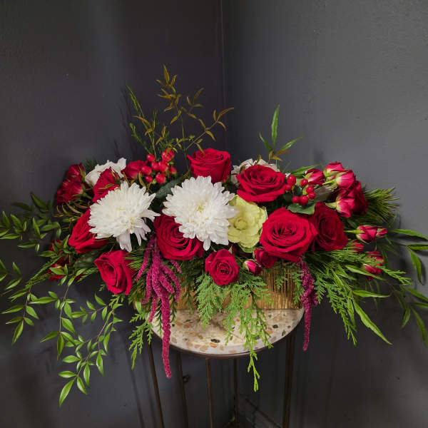 Red roses and white chrysanthemums in a low rectangular arrangement