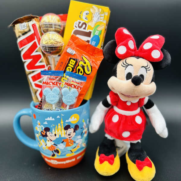 Minnie Mouse plush beside a mug filled with assorted candy