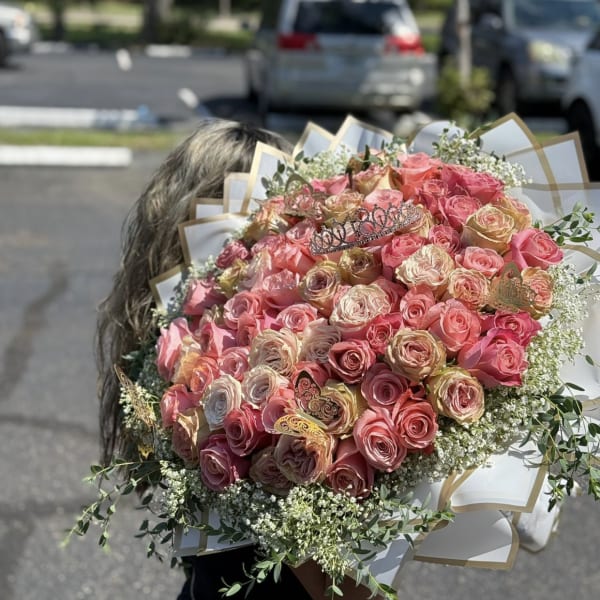 Large bouquet of pink and peach roses with white filler flowers