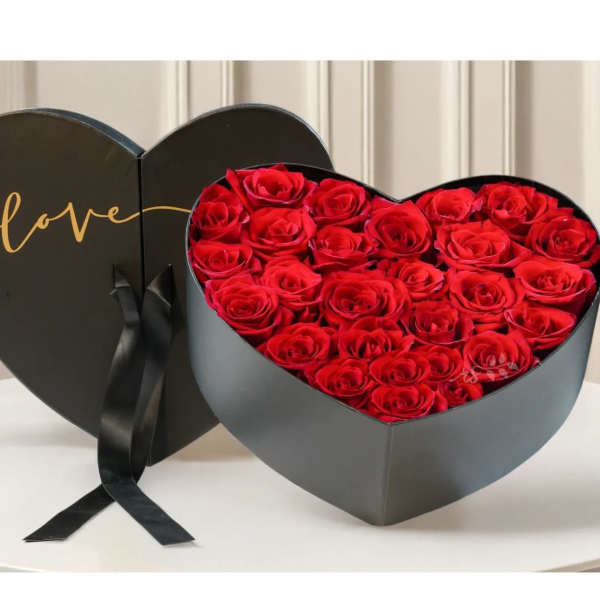 Heart-shaped box of red roses with a black lid reading love