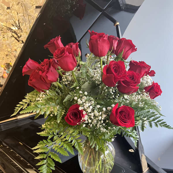 25 red roses with fillers in vase