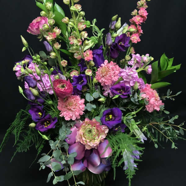 Purple and pink mixed bouquet with eucalyptus in a vase