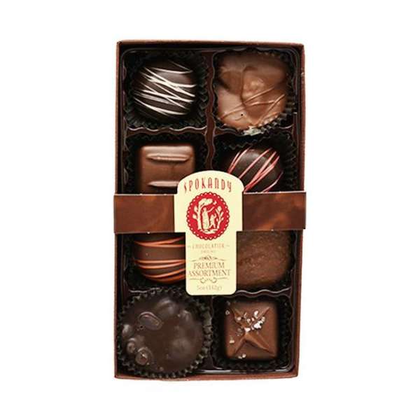 Box of assorted chocolates with a paper label and ribbon band