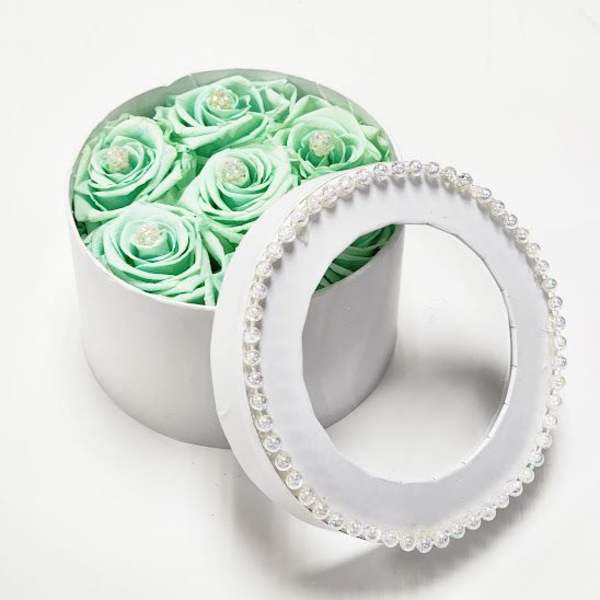 Mint green roses in a round white box with a beaded lid