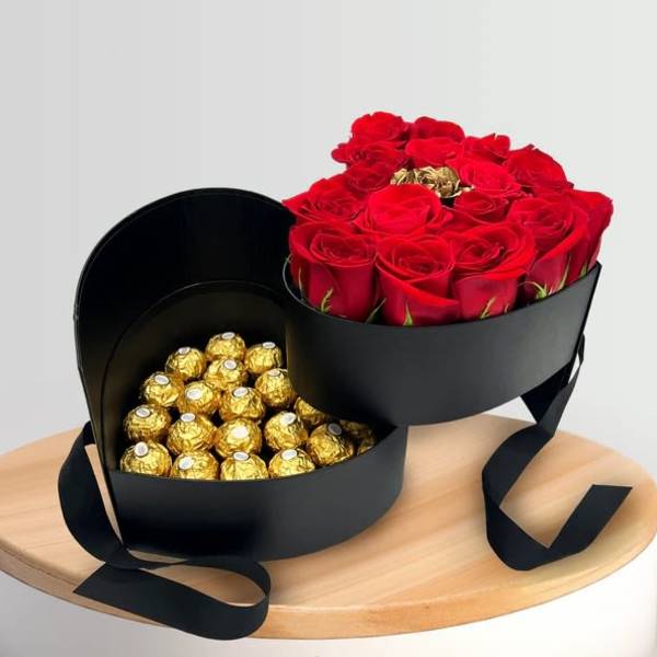 Heart-shaped box with red roses and gold-wrapped chocolates