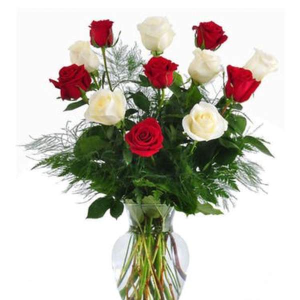 Red and white roses in a clear glass vase