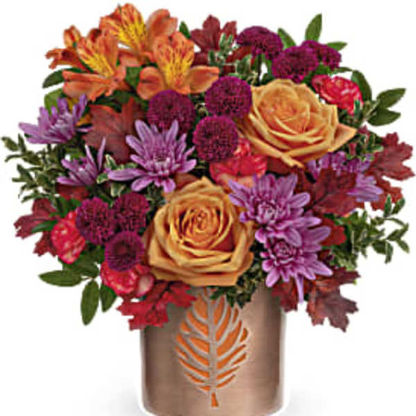 Mixed bouquet of roses and chrysanthemums in a bronze vase