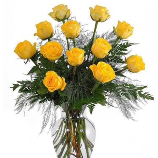 Yellow roses arranged in a clear glass vase