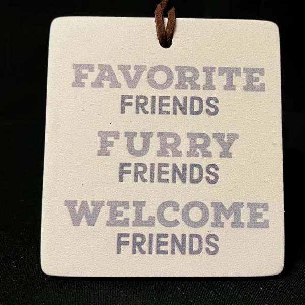 Hanging ceramic tag with the words Favorite Friends Furry Friends Welcome Friends