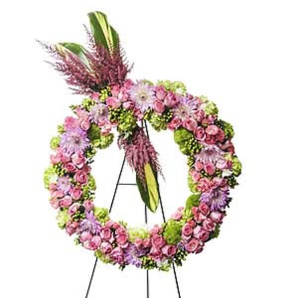 Pink and purple floral wreath on a black easel