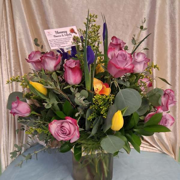 20 purple roses with tulips and mixed greens