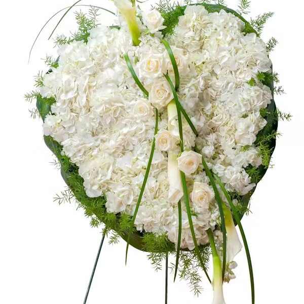 White floral standing wreath with calla lilies and roses on a metal easel