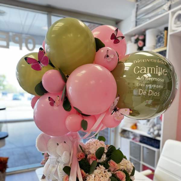 Pink and gold balloon arrangement with a teddy bear and flowers in a pink box