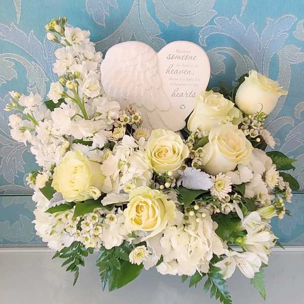 White and cream floral arrangement with roses and a heart memorial plaque