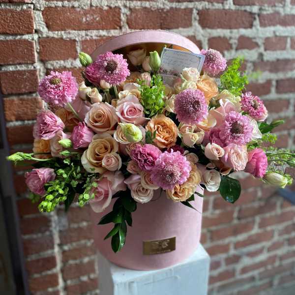 Pink and peach rose bouquet in a round pink box