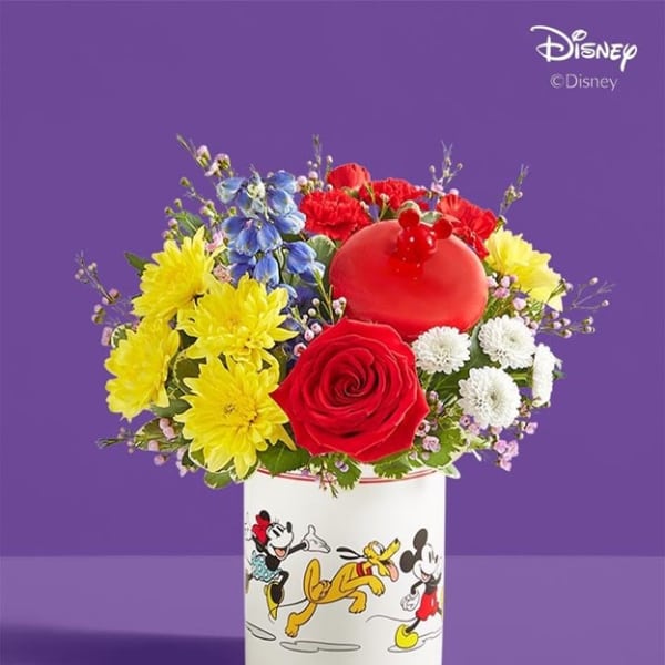 Colorful bouquet in a Disney mug with a red rose and yellow daisies