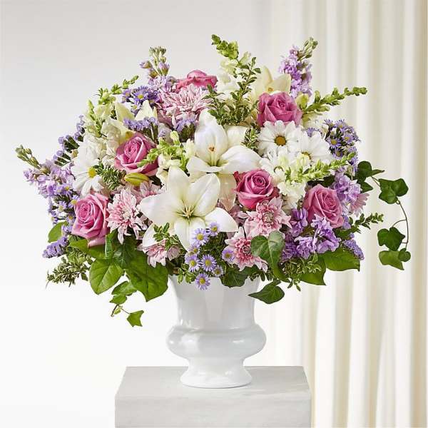 Pink and white mixed flower arrangement in a white vase