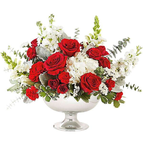 Red roses and white flowers arranged in a silver pedestal bowl