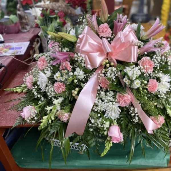 Pink Pasture with Baby Breath with Pink Bow Casket Spray