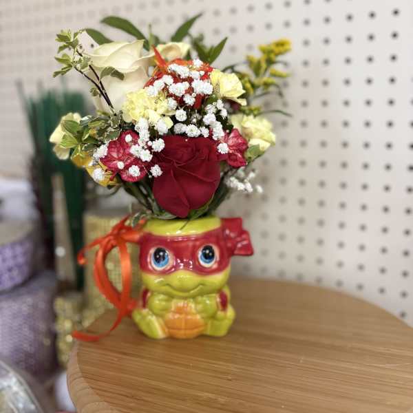 Red and cream roses in a novelty ceramic pot