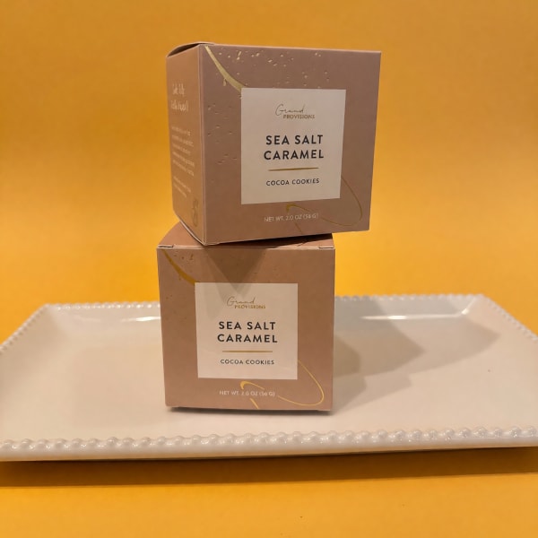 Two boxes of sea salt caramel cocoa cookies on a tray