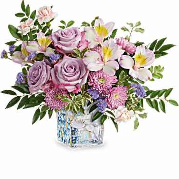Lavender roses and pink flowers in a glass vase