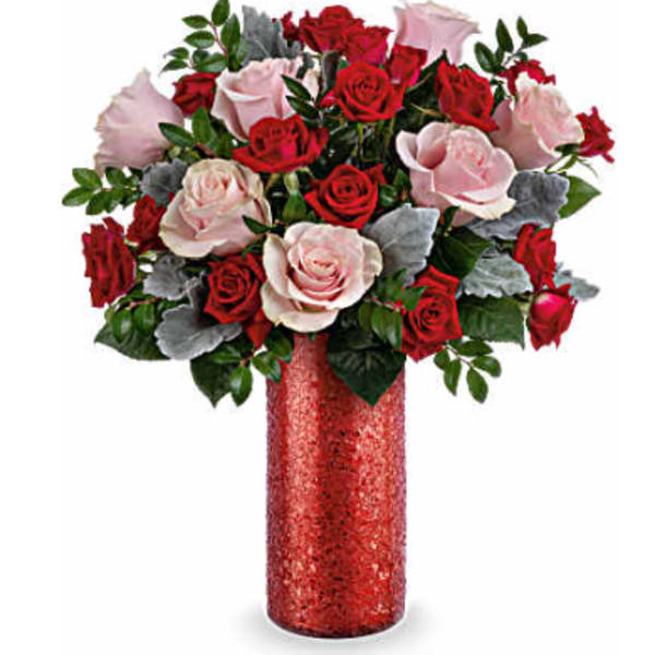 Bouquet of red and pale pink roses in a red vase