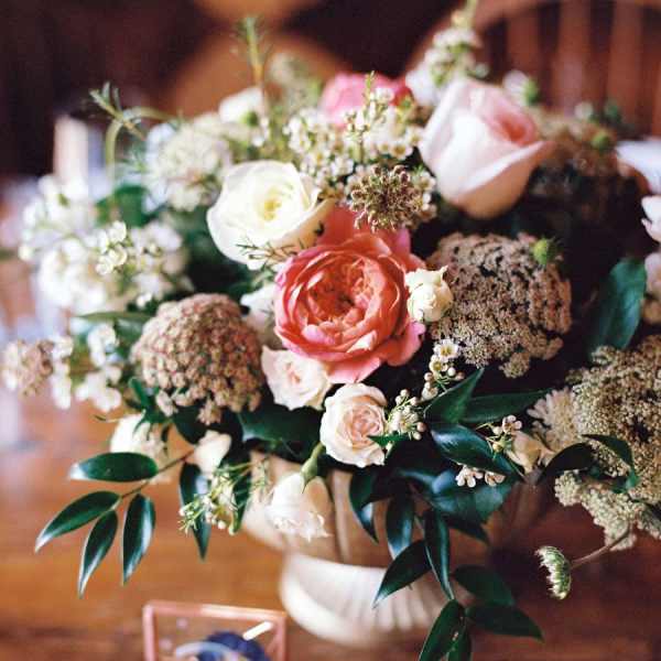 Bouquet of pink and white roses with small filler flowers