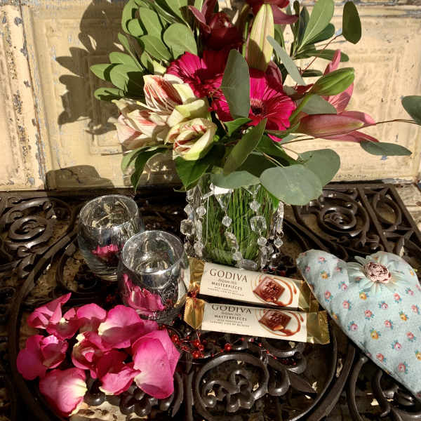 Bouquet with pink and burgundy flowers, chocolates, and a heart balloon