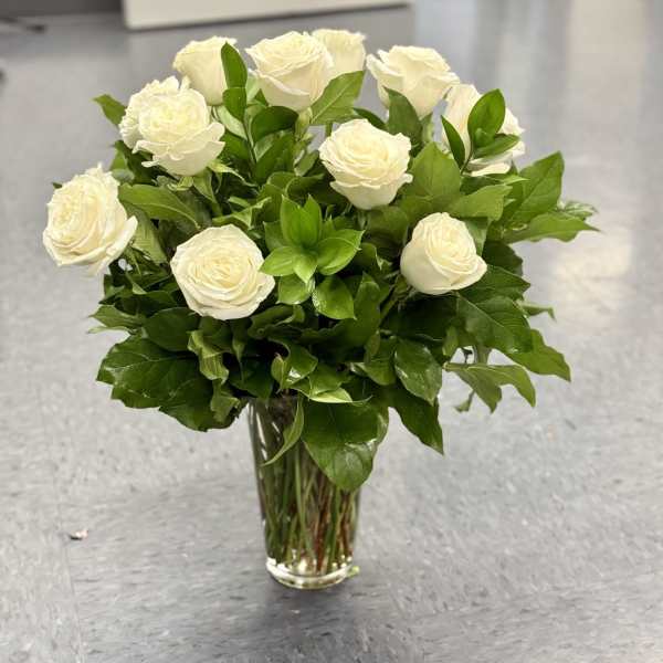 White roses arranged in a clear glass vase