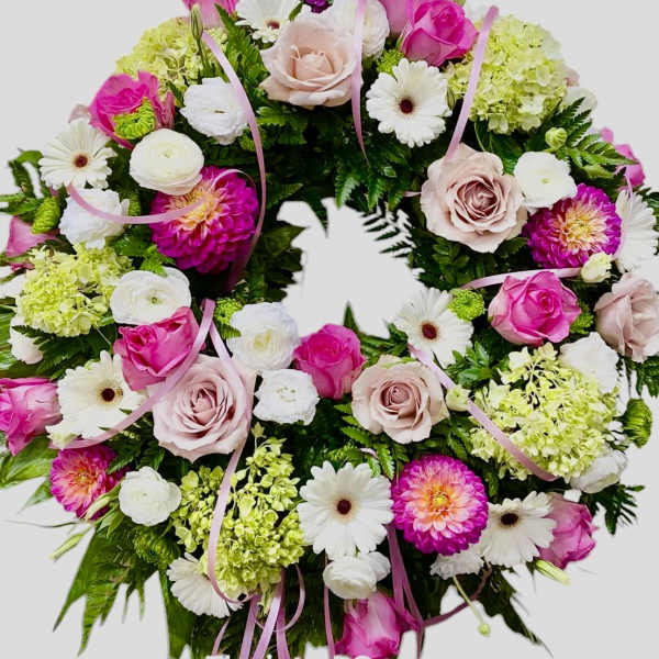 Pink and white floral wreath with roses and daisies