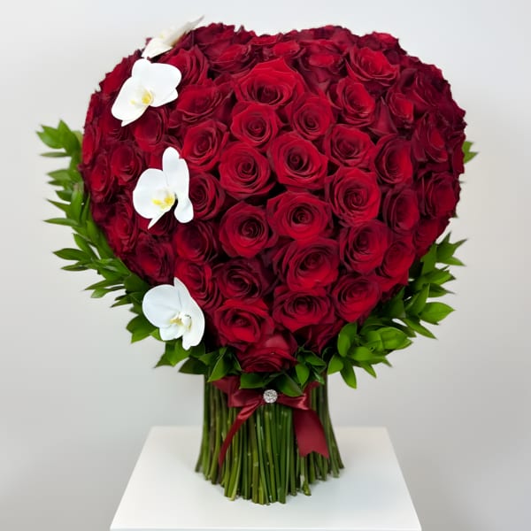 Heart-shaped bouquet of red roses with white orchids