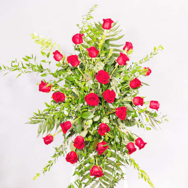 Tall arrangement of red roses on a white stand