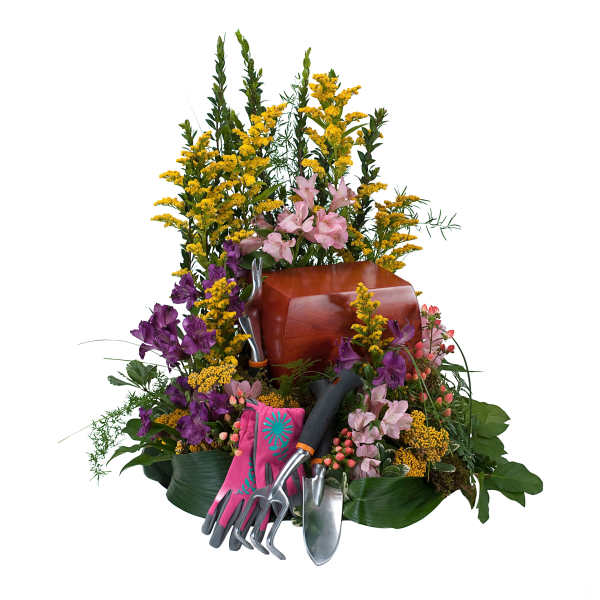 Sympathy urn arrangement with pink, purple, and yellow flowers and gardening tools with gloves