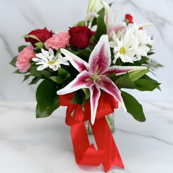 Bouquet of red roses, pink carnations, white daisies, and a pink stargazer lily with a red ribbon