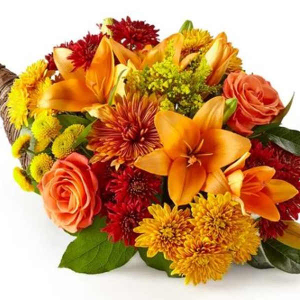 Orange and red mixed bouquet with roses and lilies in a wicker wrap