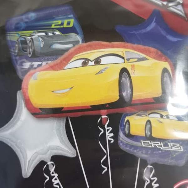 Disney Cars-themed foil balloons with a yellow race car and star shapes