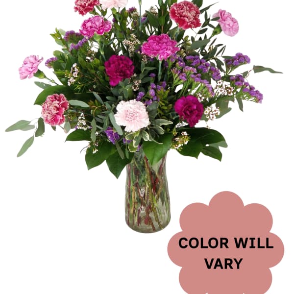Mixed pink and purple carnations in a glass vase