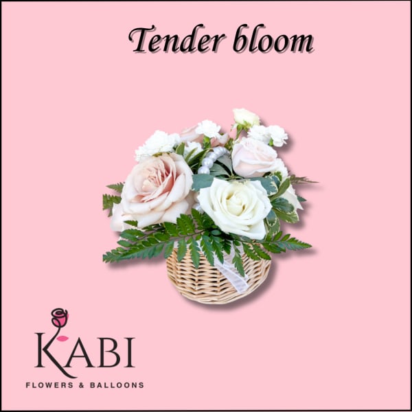 Pink and white rose arrangement in a wicker basket