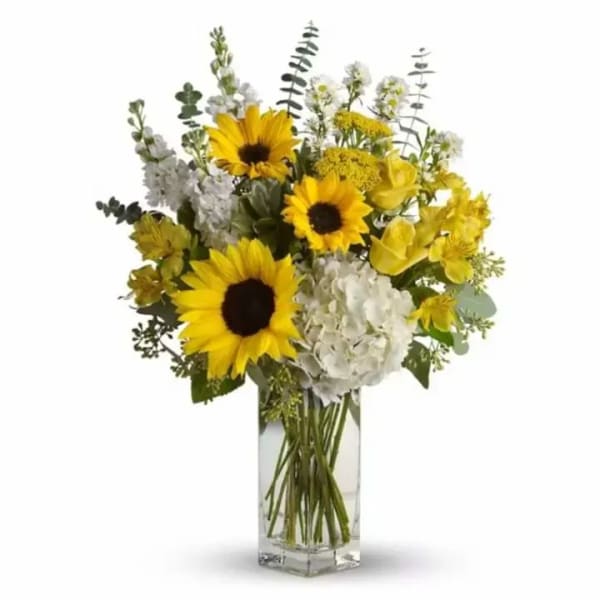 Sunflower bouquet with white blooms in a clear glass vase