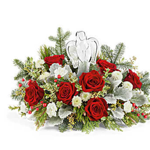Red roses and white flowers arranged with an angel ornament
