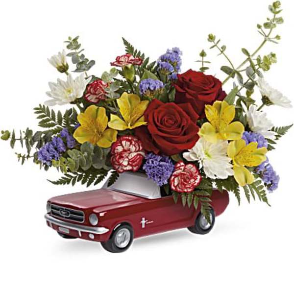 Flower arrangement in a red pickup truck container