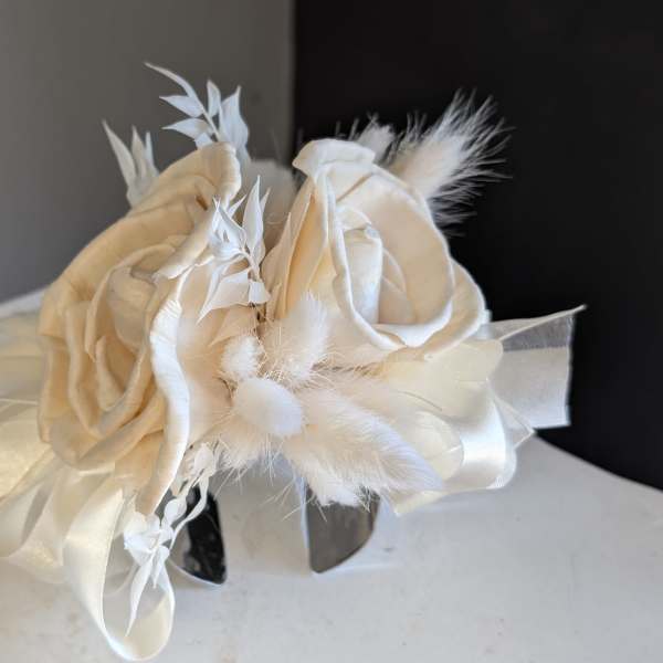 All white dried cuff corsage with silver band.