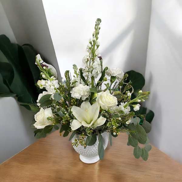 White floral arrangement in a textured white vase