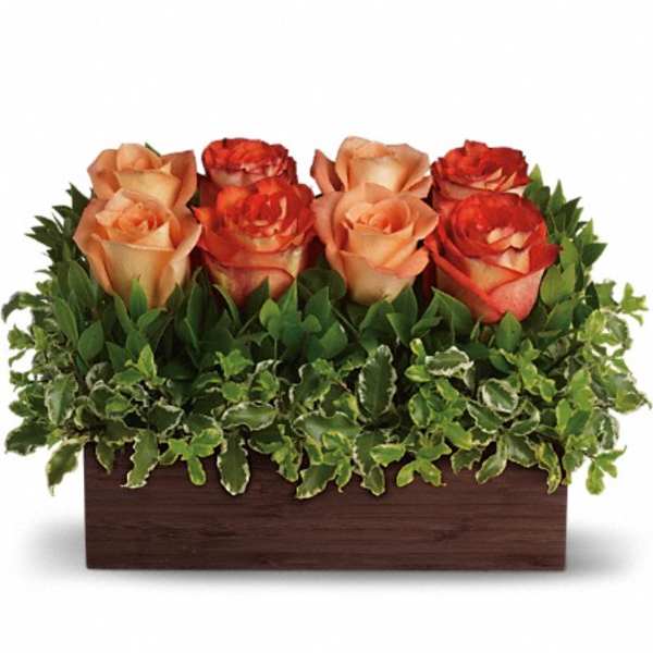 Arrangement of peach and orange roses in a rectangular wooden box