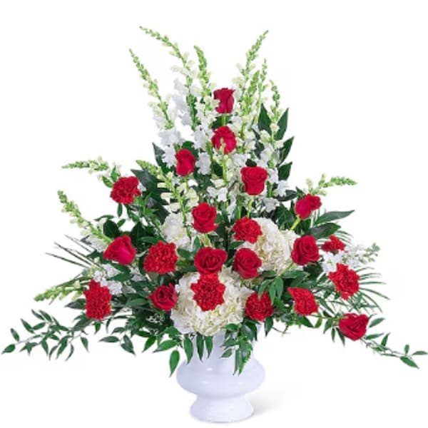 Red roses and white carnations in a white vase