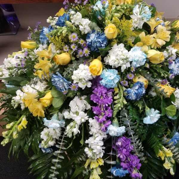 Large mixed floral spray with yellow, white, blue, and purple flowers