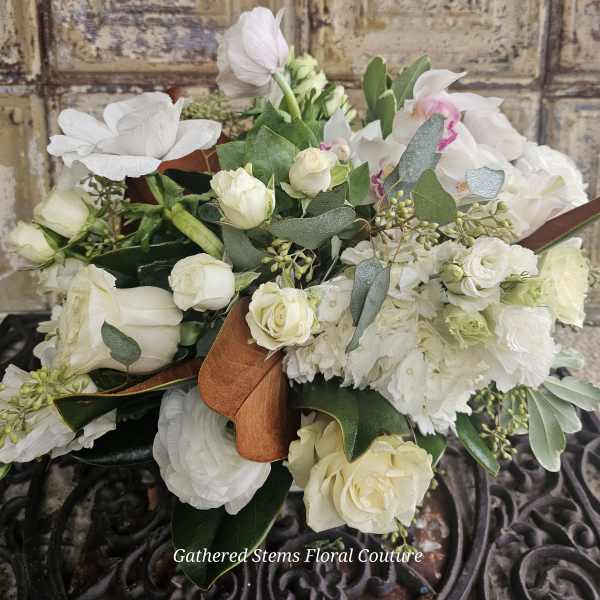 White rose and orchid bouquet with eucalyptus and ribbon