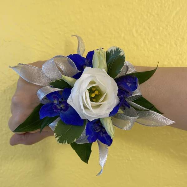 White and blue wrist corsage with silver ribbon