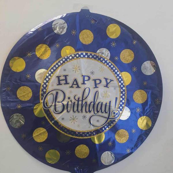 Round blue birthday balloon with gold and silver dots